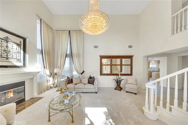 a living room with fireplace furniture and a large window