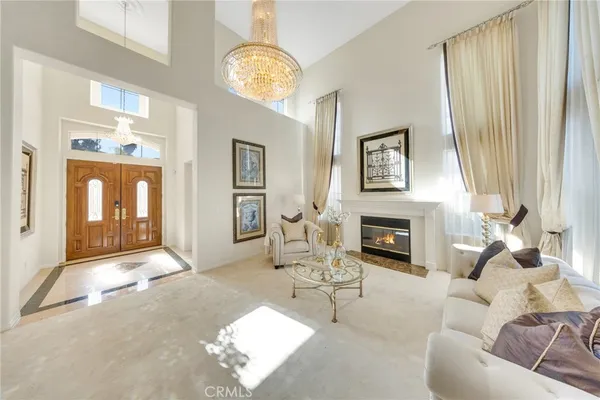 a living room with furniture and a chandelier