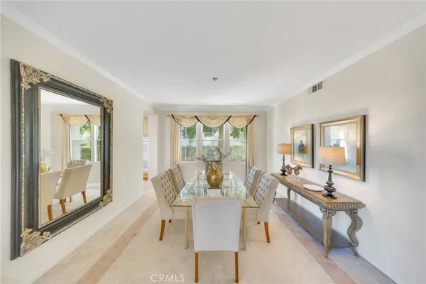 a dining room with furniture and wooden floor