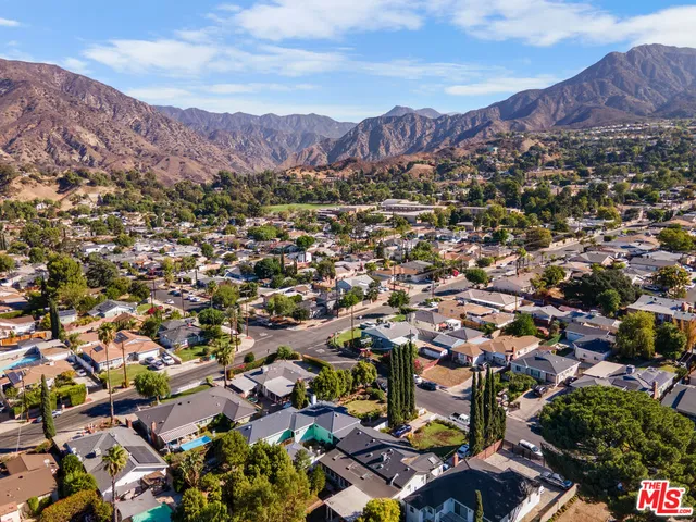an aerial view of residential house and sandy dunes