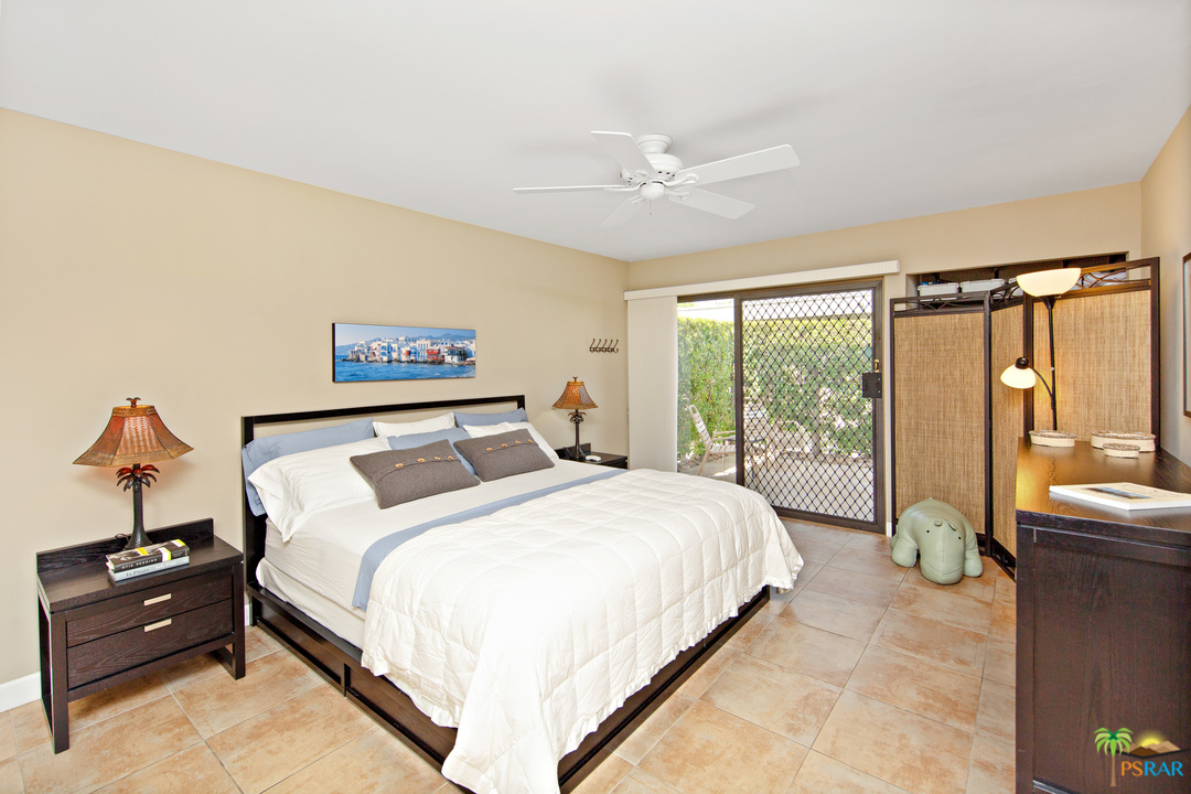 1111 East Ramon Road, Unit 6 Palm Springs, CA 92264 - Photo 11 of 32 a bedroom with a bed and a large window