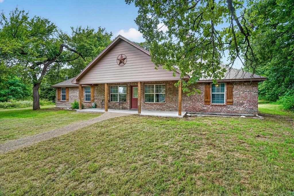 1654 Ranger Highway Weatherford, TX 76088 - Photo 2 of 31 Brick exterior with a gabled roofline and front porch with wood columns