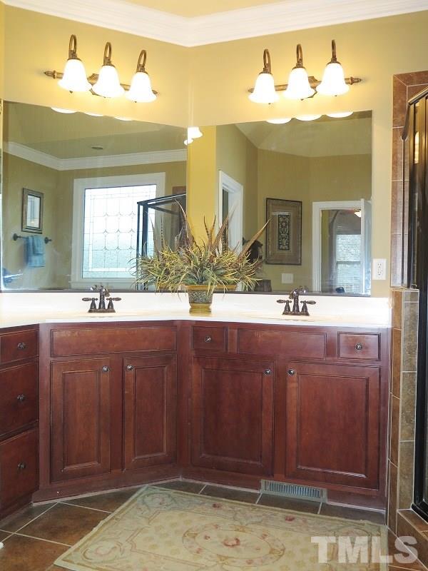 8733 Oregon Inlet Court Raleigh, NC 27603 - Photo 11 of 19 a bathroom with a sink and a mirror