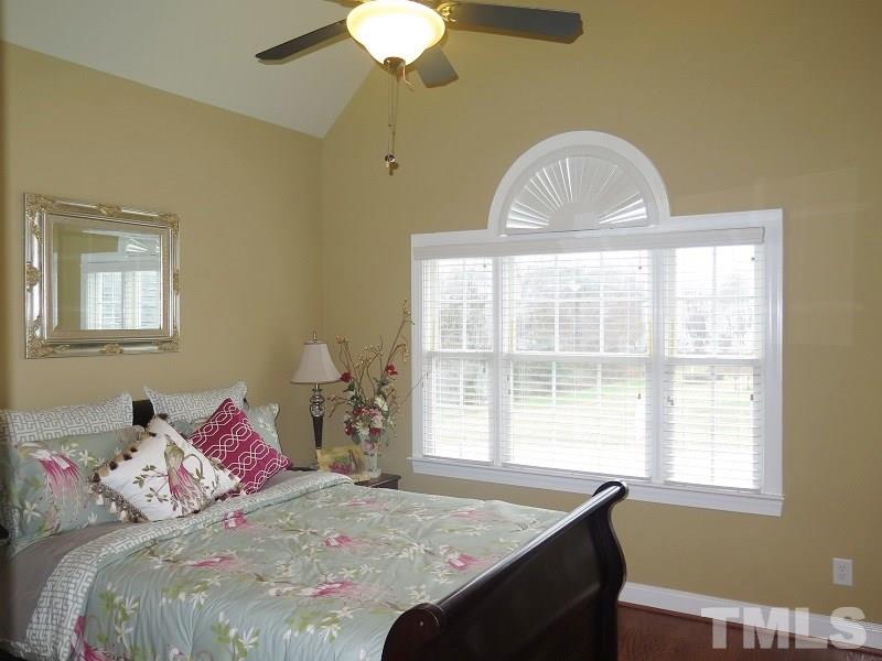 8733 Oregon Inlet Court Raleigh, NC 27603 - Photo 12 of 19 a bedroom with a bed and a window
