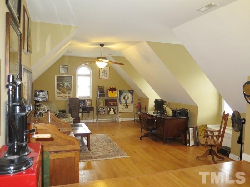 8733 Oregon Inlet Court Raleigh, NC 27603 - Photo 15 of 19 a living room with furniture and a large mirror