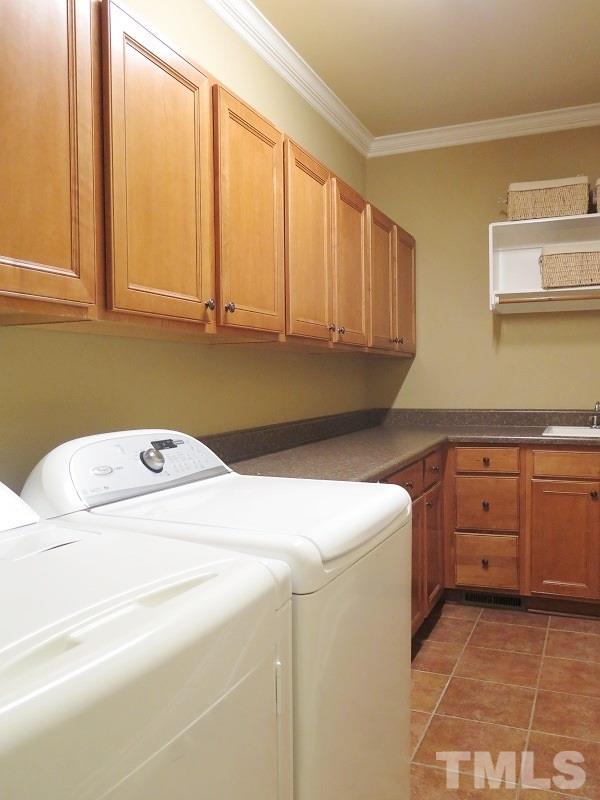 8733 Oregon Inlet Court Raleigh, NC 27603 - Photo 16 of 19 a utility room with dryer and washer