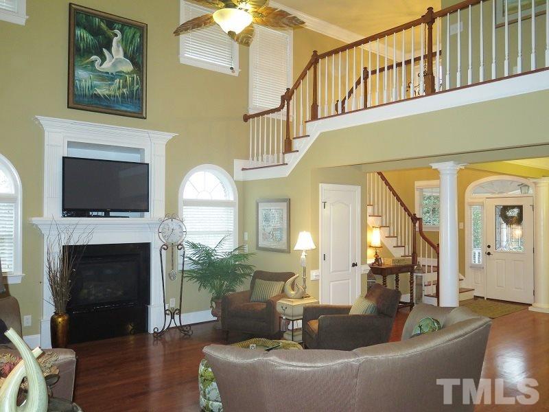 8733 Oregon Inlet Court Raleigh, NC 27603 - Photo 5 of 19 a living room with furniture a fireplace and a flat screen tv