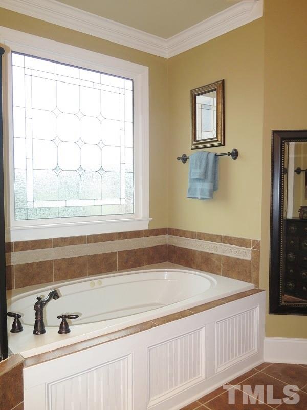 8733 Oregon Inlet Court Raleigh, NC 27603 - Photo 10 of 19 a bath tub sitting next to a window