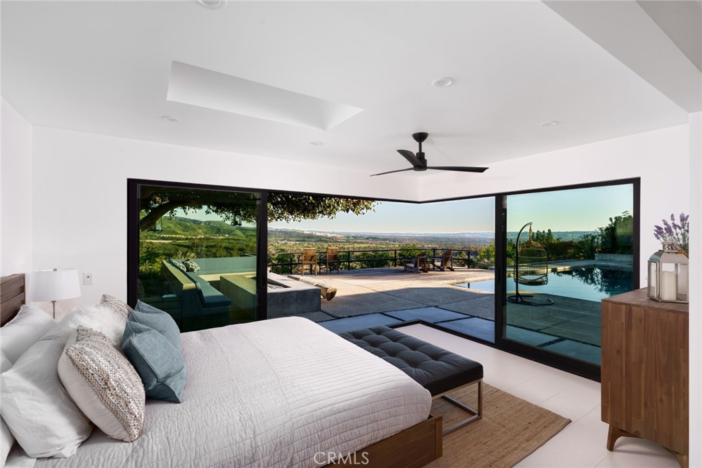 10631 Equestrian Drive North Tustin, CA 92705 - Photo 12 of 35 a bedroom with a bed and large windows