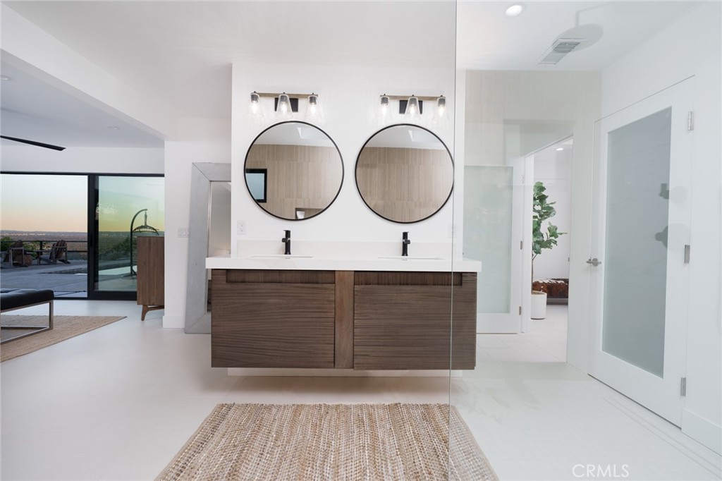 10631 Equestrian Drive North Tustin, CA 92705 - Photo 14 of 35 a bathroom with a sink a mirror and vanity