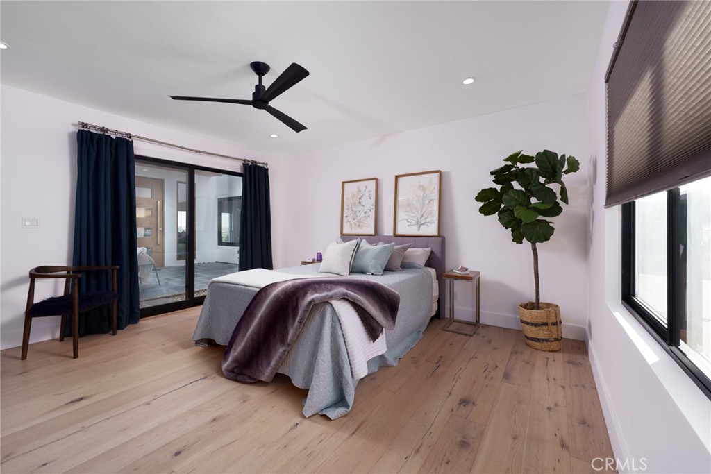 10631 Equestrian Drive North Tustin, CA 92705 - Photo 17 of 35 a bedroom with a bed and wooden floor