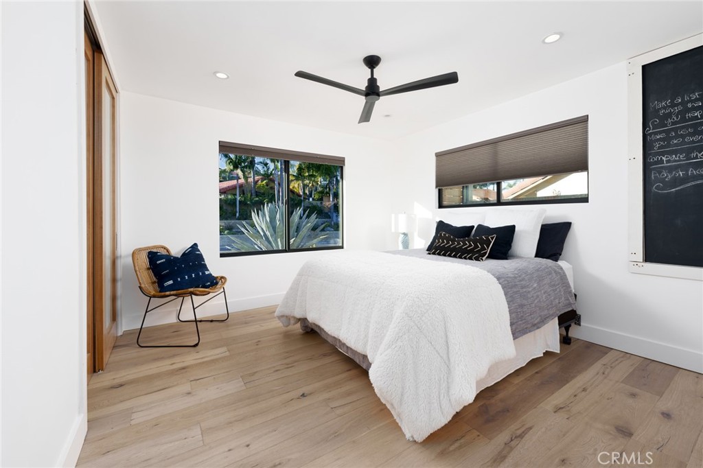 10631 Equestrian Drive North Tustin, CA 92705 - Photo 18 of 35 a bedroom with a bed and glass window