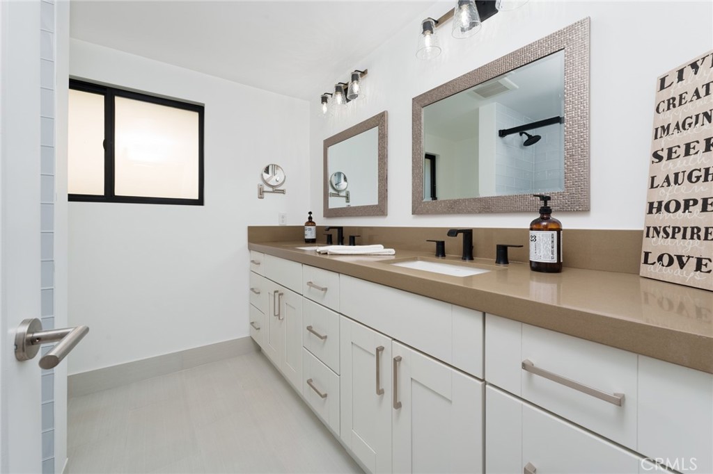 10631 Equestrian Drive North Tustin, CA 92705 - Photo 20 of 35 a bathroom with double sink and a mirror