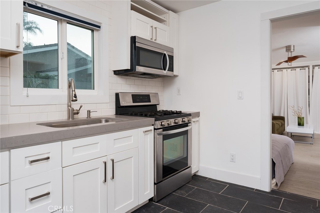 10631 Equestrian Drive North Tustin, CA 92705 - Photo 23 of 35 a kitchen with cabinets stainless steel appliances and a sink