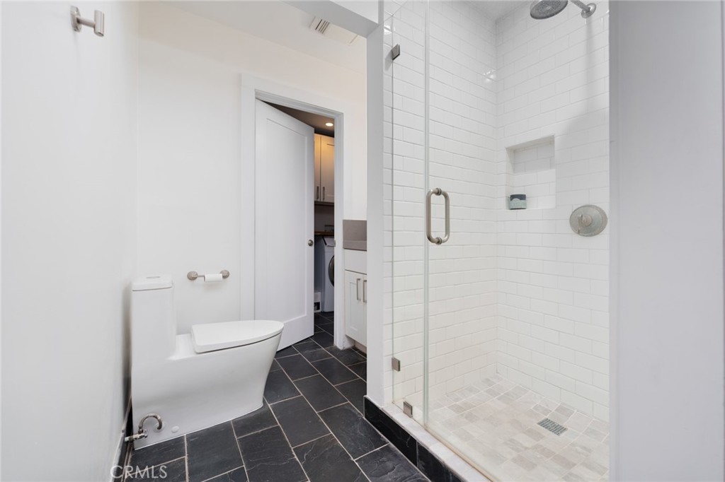 10631 Equestrian Drive North Tustin, CA 92705 - Photo 25 of 35 a bathroom with a glass shower door