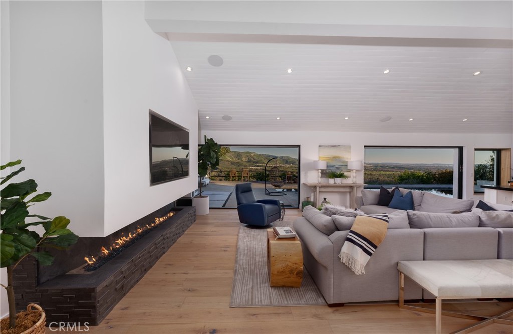 10631 Equestrian Drive North Tustin, CA 92705 - Photo 3 of 35 a living room with furniture tv and a potted plant