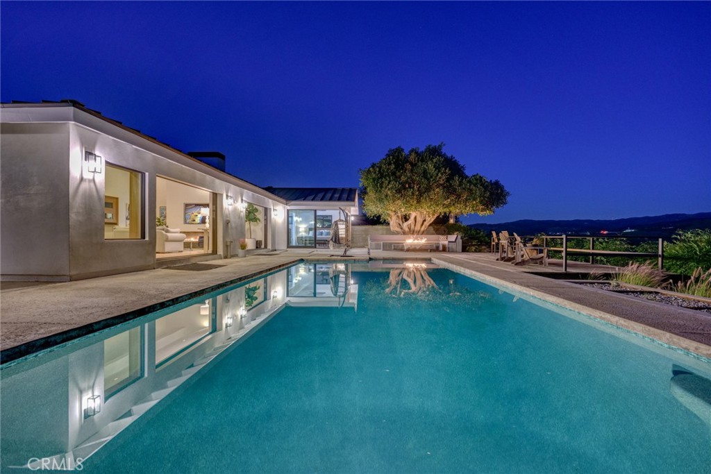 10631 Equestrian Drive North Tustin, CA 92705 - Photo 34 of 35 a view of a swimming pool with an outdoor seating and a yard
