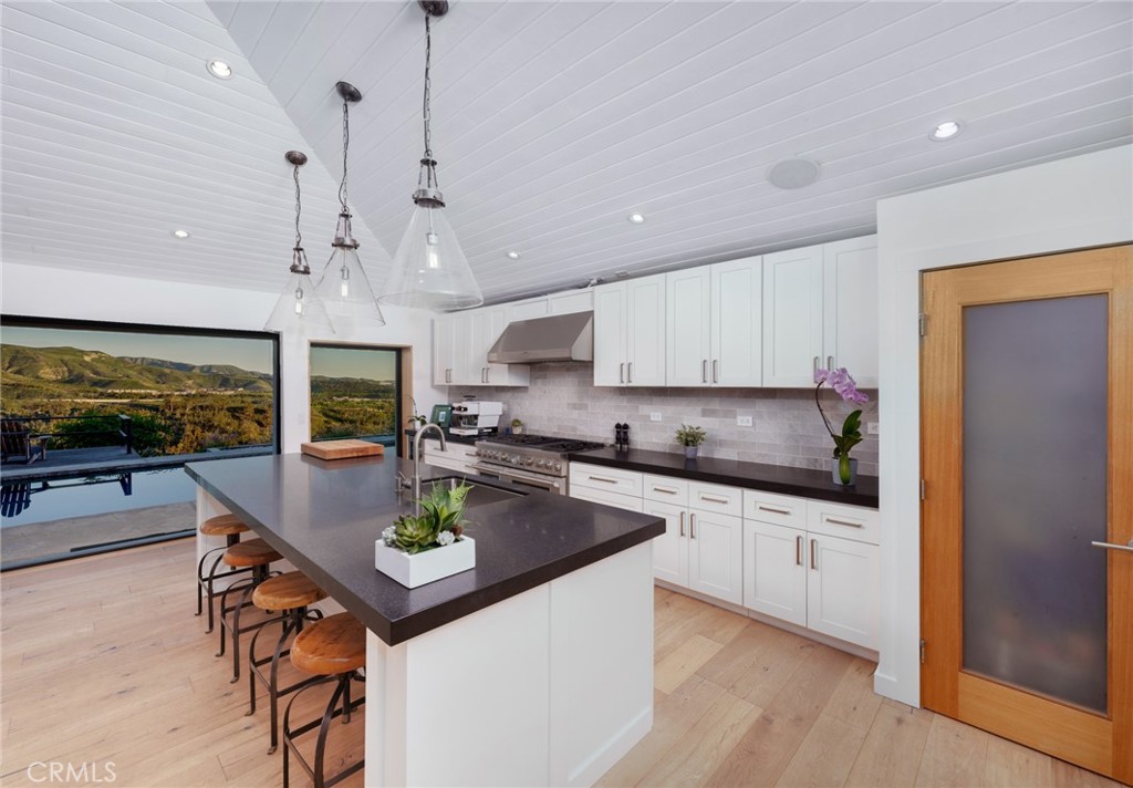 10631 Equestrian Drive North Tustin, CA 92705 - Photo 7 of 35 a kitchen with stainless steel appliances granite countertop a sink a stove and a refrigerator