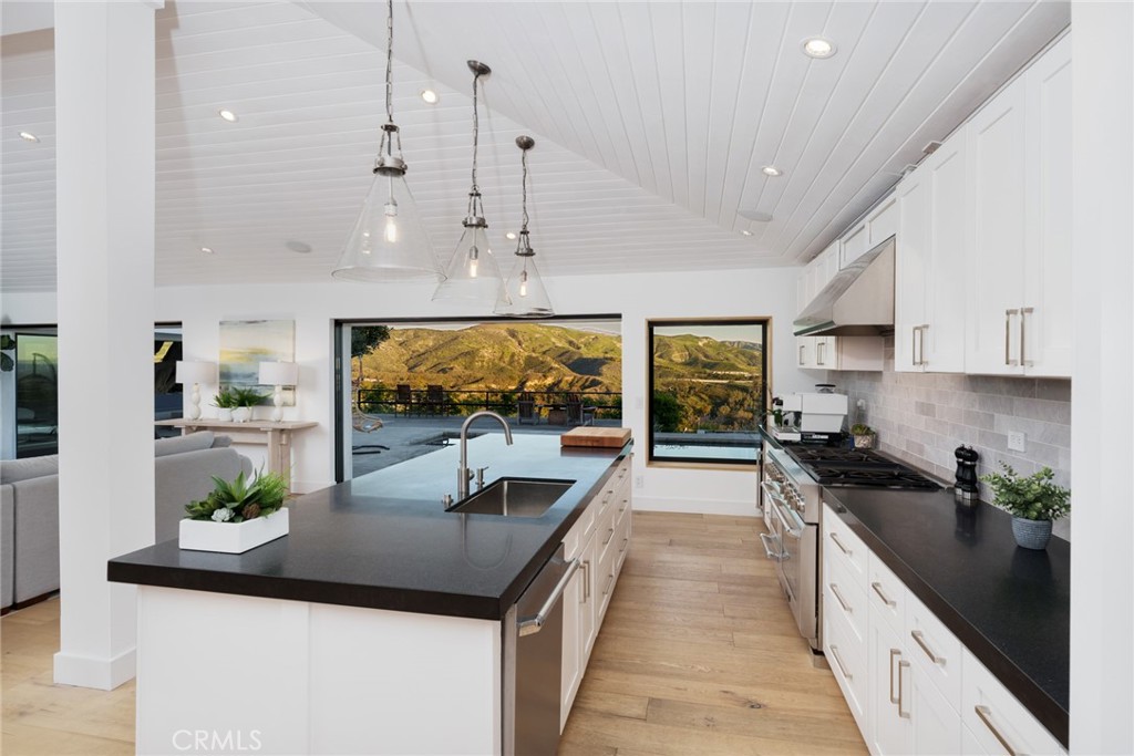 10631 Equestrian Drive North Tustin, CA 92705 - Photo 8 of 35 a kitchen with stainless steel appliances kitchen island granite countertop a sink and cabinets