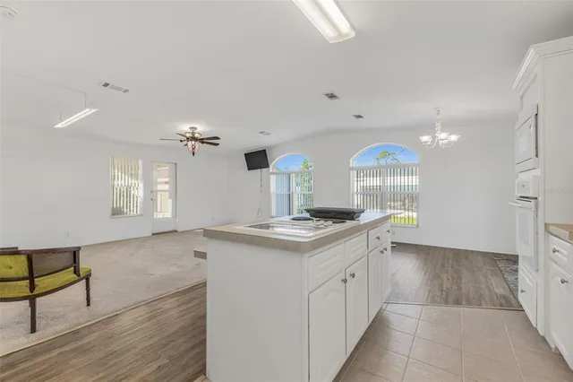 a kitchen with a sink cabinets and window
