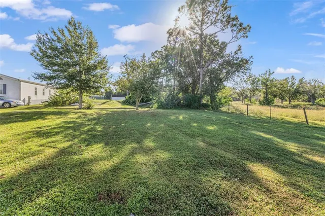 a view of a house with yard and sitting area