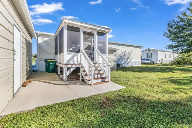 a balcony with wooden floor table and chairs