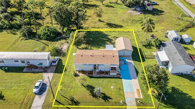 an aerial view of residential houses with outdoor space and river