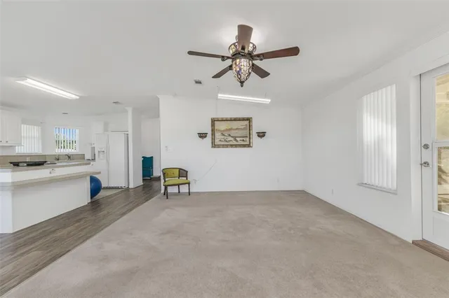 a view of a livingroom with a kitchen and a window