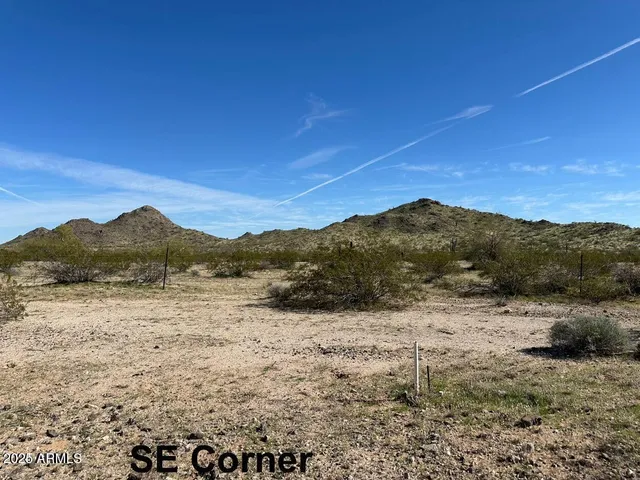 a view of mountain with sunset in background