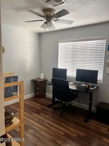 a view of a workspace with furniture and a window