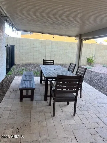 a view of a backyard with table and chairs