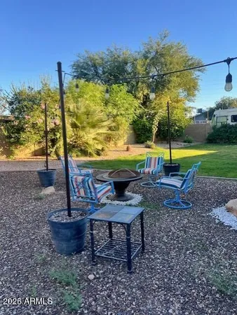 a view of a swimming pool with a yard and sitting area