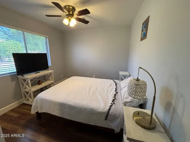 a bedroom with a bed and a flat screen tv