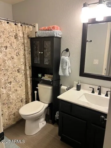 a bathroom with a sink toilet and mirror