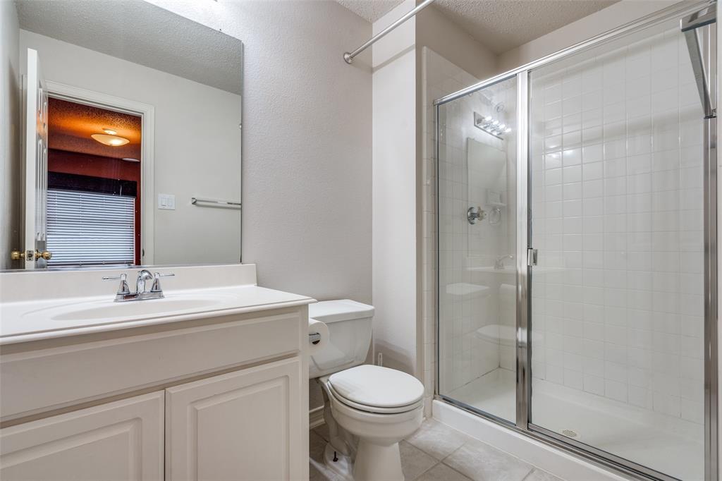 3421 Neiman Road Plano, TX 75025 - Photo 29 of 40 Bathroom with a shower stall, vanity, and tile patterned flooring