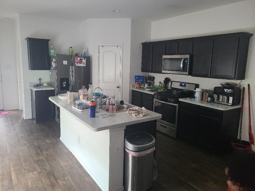 2331 Sandcherry Ln Spring Spring, TX 77373 - Photo 3 of 10 a kitchen with a sink stove top oven and refrigerator