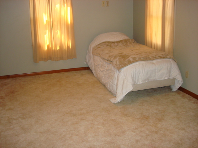 378 Van Orin Road Sublette, IL 61367 - Photo 18 of 25 a bed sitting in a spacious bedroom next to a window