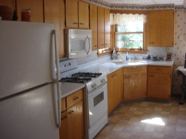 378 Van Orin Road Sublette, IL 61367 - Photo 4 of 25 a kitchen with a stove a sink and a refrigerator