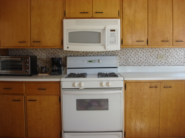 378 Van Orin Road Sublette, IL 61367 - Photo 5 of 25 a kitchen with a stove and a microwave
