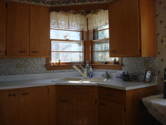 378 Van Orin Road Sublette, IL 61367 - Photo 7 of 25 a kitchen with granite countertop stainless steel appliances a sink window and cabinets