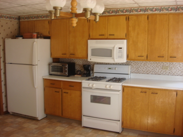 378 Van Orin Road Sublette, IL 61367 - Photo 8 of 25 a kitchen with a white cabinets and white appliances
