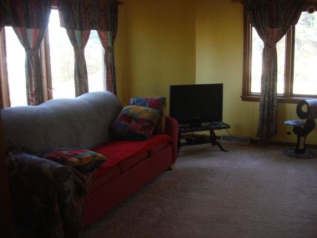 378 Van Orin Road Sublette, IL 61367 - Photo 10 of 25 a living room with furniture and a flat screen tv