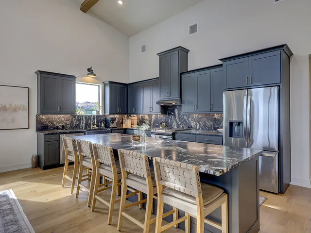 a kitchen with stainless steel appliances granite countertop a sink stove and cabinets