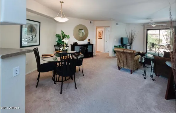 a living room with furniture plant and a window