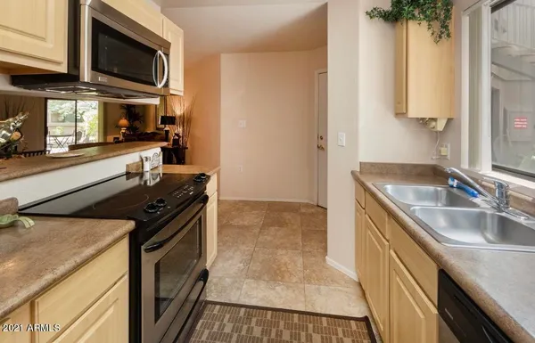 a kitchen with stainless steel appliances granite countertop a stove and a microwave
