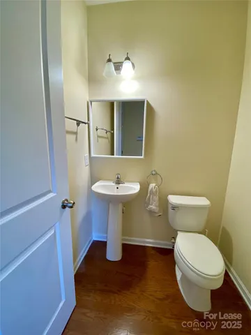 a bathroom with a sink toilet and mirror