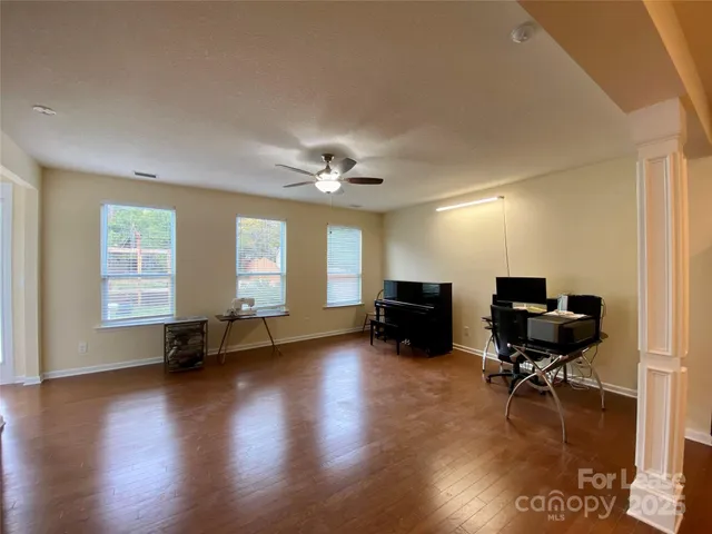 a view of a livingroom with workspace and a window