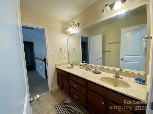 a bathroom with a sink double vanity and a mirror