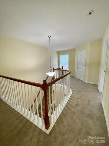 a view of a hallway with staircase