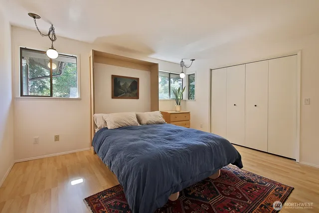 a spacious bedroom with a bed and a window